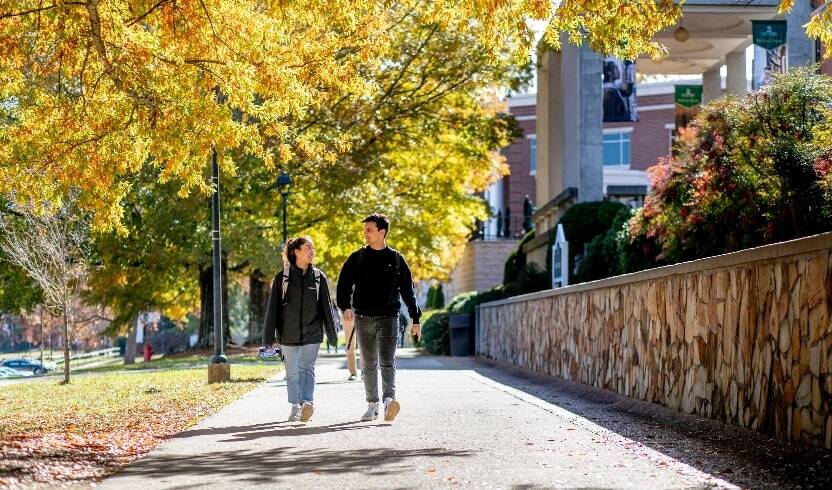 students walking on campus in the fall-min